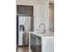 Contemporary kitchen with stainless steel refrigerator and a convenient island with a sink at 16798 W 94Th Way, Arvada, CO 80007