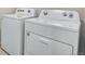 A white, front-loading Whirlpool washer and dryer set are featured in the laundry area at 16798 W 94Th Way, Arvada, CO 80007