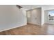 Bright living area with hardwood floors, staircase, and natural light from large windows at 16798 W 94Th Way, Arvada, CO 80007
