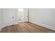 Bright bedroom featuring wood floors and an open doorway to an ensuite bathroom at 715 W 7Th Ave, Denver, CO 80204