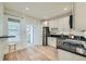 Bright eat-in kitchen with stainless appliances, dark counters, and access to a separate room at 715 W 7Th Ave, Denver, CO 80204