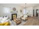 Bright living room featuring a fireplace, neutral furniture, and wood floors at 715 W 7Th Ave, Denver, CO 80204