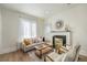 Comfortable living room with a decorative fireplace and lots of natural light at 715 W 7Th Ave, Denver, CO 80204