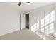 Carpeted bedroom showcasing a closet and door, filled with natural light at 3194 W 9Th Avenue Pl, Broomfield, CO 80020
