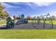 Community playground featuring slides, swings, and climbing structures on a lush green lawn at 3194 W 9Th Avenue Pl, Broomfield, CO 80020