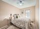 Bedroom with a queen bed, ceiling fan, and window at 9471 W 93Rd Ave, Broomfield, CO 80021