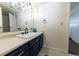Small bathroom with single vanity and blue cabinets at 974 S Zeno Way, Aurora, CO 80017
