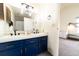 Bathroom with double vanity and blue cabinets at 974 S Zeno Way, Aurora, CO 80017