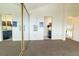 Upstairs bedroom with mirrored closet and access to bathroom at 974 S Zeno Way, Aurora, CO 80017