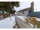 Exterior view of house with walkway and snow at 974 S Zeno Way, Aurora, CO 80017