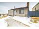 Cute house exterior, snow on the ground, walkway to the front door at 974 S Zeno Way, Aurora, CO 80017