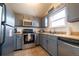 Modern kitchen with gray cabinets and stainless steel appliances at 974 S Zeno Way, Aurora, CO 80017