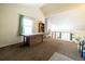 Bright loft area with high ceilings, carpeted floor, and views to the living room below at 974 S Zeno Way, Aurora, CO 80017