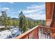 Mountain view from a wood balcony with pine trees and snow covered ground at 439 Ronnie Rd, Golden, CO 80403