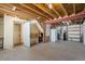 Unfinished basement featuring exposed beams, storage shelves, and a doorway, ready to be personalized at 439 Ronnie Rd, Golden, CO 80403