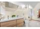 Bright bathroom features a double vanity, a large mirror, and a glass-enclosed shower at 439 Ronnie Rd, Golden, CO 80403