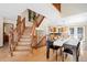 Elegant dining area with wooden staircase, dining table and kitchen access, creating a cozy atmosphere at 439 Ronnie Rd, Golden, CO 80403