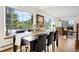 Dining room with a large dark table, chairs, and many windows overlooking the wooded yard at 439 Ronnie Rd, Golden, CO 80403