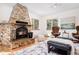 Cozy living room with a stone fireplace, hardwood floors, and picturesque windows at 439 Ronnie Rd, Golden, CO 80403