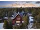 Aerial view of a beautiful house nestled in a dense forest, with mountains in the distance at 439 Ronnie Rd, Golden, CO 80403