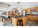 Kitchen and dining area featuring wood cabinets, dark counters, stainless steel appliances, and adjacent dining area at 439 Ronnie Rd, Golden, CO 80403