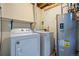 Utility room with a side-by-side washer and dryer and a hot water heater at 439 Ronnie Rd, Golden, CO 80403