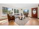 Bright living room boasting large windows, hardwood floors, and a neutral color scheme, offering scenic outdoor views at 439 Ronnie Rd, Golden, CO 80403