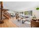 Bright living room featuring a wood staircase, hardwood floors, neutral tones, and large windows overlooking the yard at 439 Ronnie Rd, Golden, CO 80403
