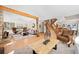 Spacious living room area with light hardwood floors, a cozy fireplace, and a staircase at 439 Ronnie Rd, Golden, CO 80403