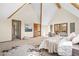 Spacious carpeted bedroom with vaulted ceilings, wood beams, and a walk-out balcony at 439 Ronnie Rd, Golden, CO 80403