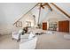Bright and airy main bedroom features vaulted ceilings with wood beams, seating area, and large windows at 439 Ronnie Rd, Golden, CO 80403