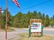 Community Hall bulletin board announces upcoming events next to a paved road and trees at 439 Ronnie Rd, Golden, CO 80403