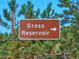 Gross Reservoir sign indicating the location surrounded by pine trees and blue sky at 439 Ronnie Rd, Golden, CO 80403