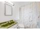 Fresh bathroom with a marble-patterned shower curtain and light green sink, offering a serene and modern bathing space at 1010 Emporia St, Aurora, CO 80010