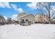 Backyard featuring a wooden deck with patio furniture and a barbecue grill, all surrounded by a snow-covered yard at 5229 Nighthawk Pkwy, Brighton, CO 80601