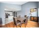 Bright dining room with hardwood floors and kitchen view at 5229 Nighthawk Pkwy, Brighton, CO 80601