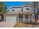 Charming two-story home featuring a welcoming porch and an attached two-car garage at 5229 Nighthawk Pkwy, Brighton, CO 80601
