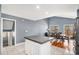 Bright kitchen with white cabinets, island, stainless steel appliances, and an adjacent dining area at 5229 Nighthawk Pkwy, Brighton, CO 80601