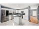 Bright kitchen features stainless steel appliances, a functional island, and contrasting countertops at 5229 Nighthawk Pkwy, Brighton, CO 80601
