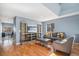 Open-concept living room with hardwood floors, media center, and ample seating at 5229 Nighthawk Pkwy, Brighton, CO 80601