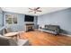 Comfortable living room with hardwood floors, fireplace, and comfortable seating at 5229 Nighthawk Pkwy, Brighton, CO 80601