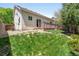 Spacious backyard features lush grass, a deck and mature trees at 12666 Davis St, Broomfield, CO 80020