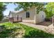 Backyard view featuring a wooden deck, grassy area, and well-maintained landscaping at 12666 Davis St, Broomfield, CO 80020
