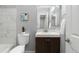 Cozy bathroom featuring marble tiling, modern vanity and fixtures, and neutral wall paint at 12666 Davis St, Broomfield, CO 80020