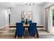 Dining room featuring wood table, hardwood floors, modern chandelier and natural light at 12666 Davis St, Broomfield, CO 80020