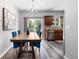 Dining room with wood table, hardwood floors, chandelier and sliding glass door at 12666 Davis St, Broomfield, CO 80020