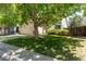 Home exterior with mature trees, manicured lawn, and concrete driveway at 12666 Davis St, Broomfield, CO 80020
