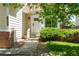 Home's front entrance features a white door, brick accents and a small yard at 12666 Davis St, Broomfield, CO 80020