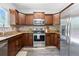Kitchen with stainless steel appliances, custom cabinets and granite countertops at 12666 Davis St, Broomfield, CO 80020