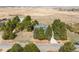Aerial shot of home showcasing mature trees and spacious yard and long driveway at 12579 Appaloosa Pl, Broomfield, CO 80020